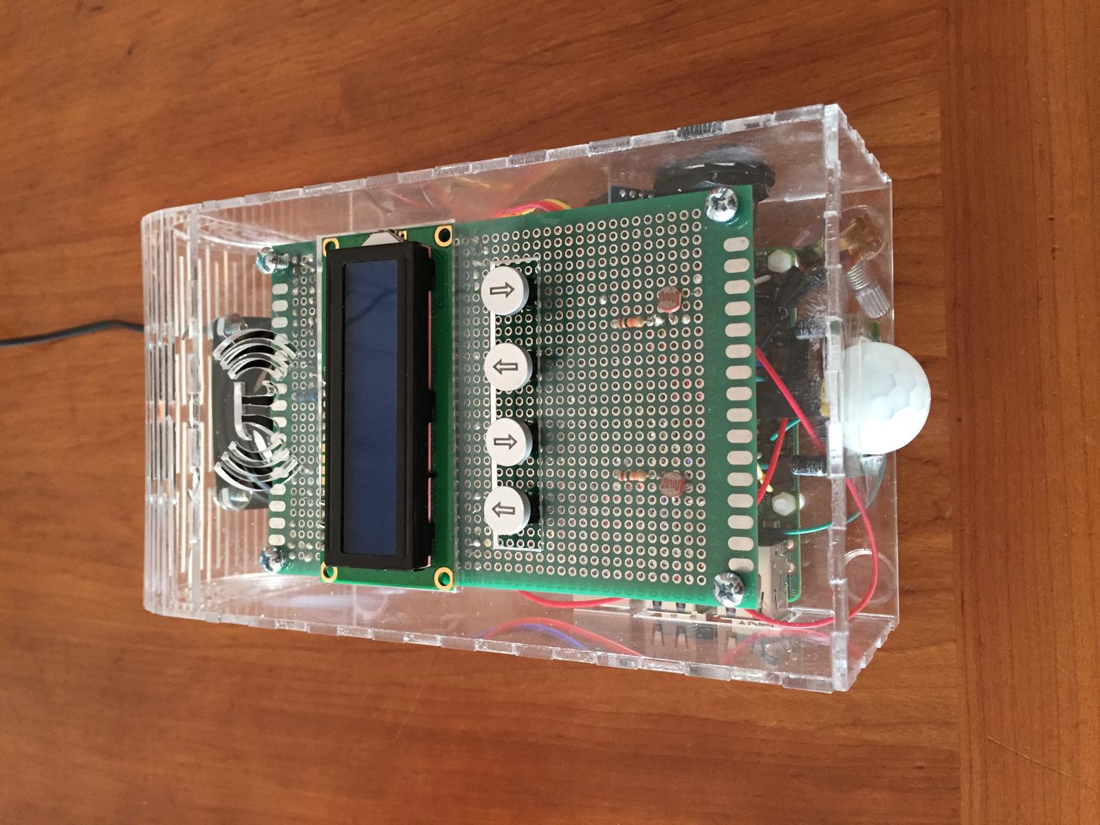 The finished alarm clock from above: LCD, buttons, motion sensor, and speaker grille
