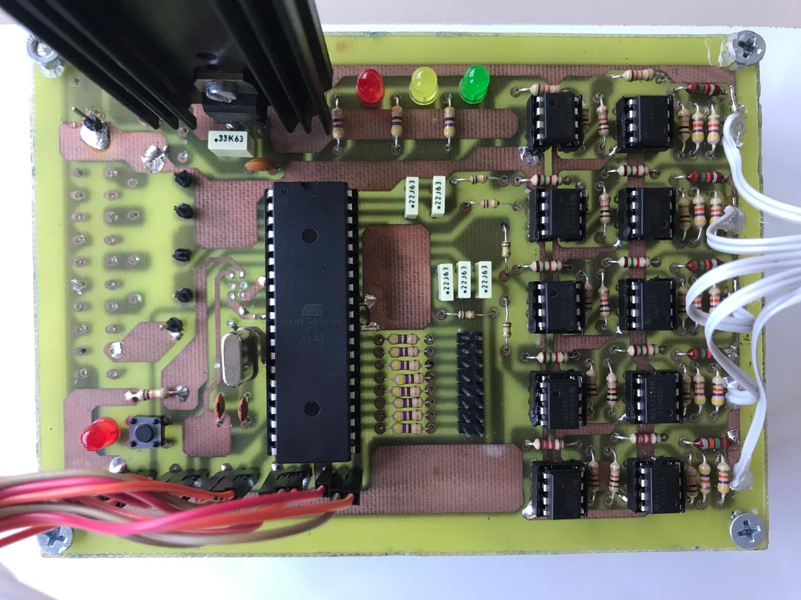The home-etched control board: the microcontroller in the middle, one operational amplifier per finger on the right