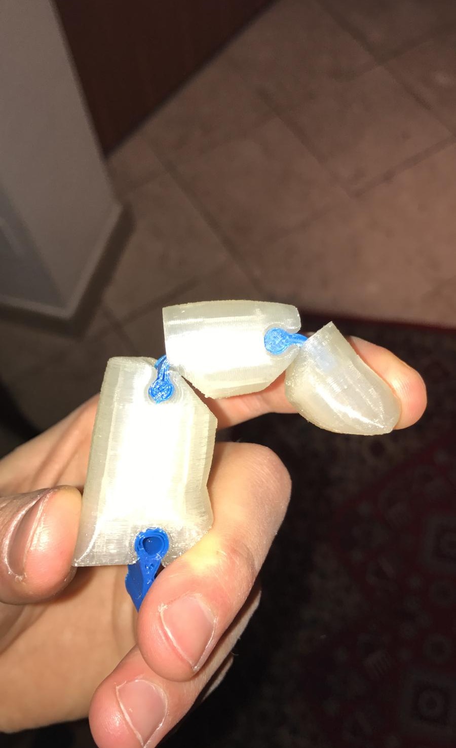 A printed finger, with the elastomer joints in blue