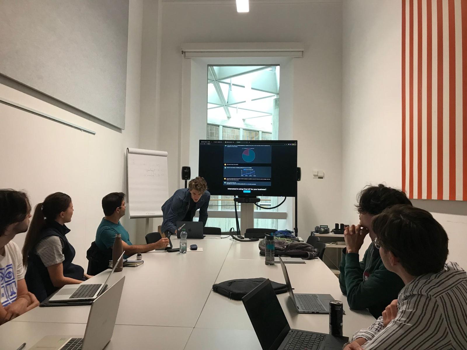 Demoing ChatIoT to the room: a dashboard you can query in natural language, ending on "Interested in using Chat IoT for your business?"