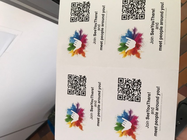 A printed sheet of SYT flyers, each with the Shaka logo, a QR code, and the line "Join SeeYouThere! and meet people around you!"