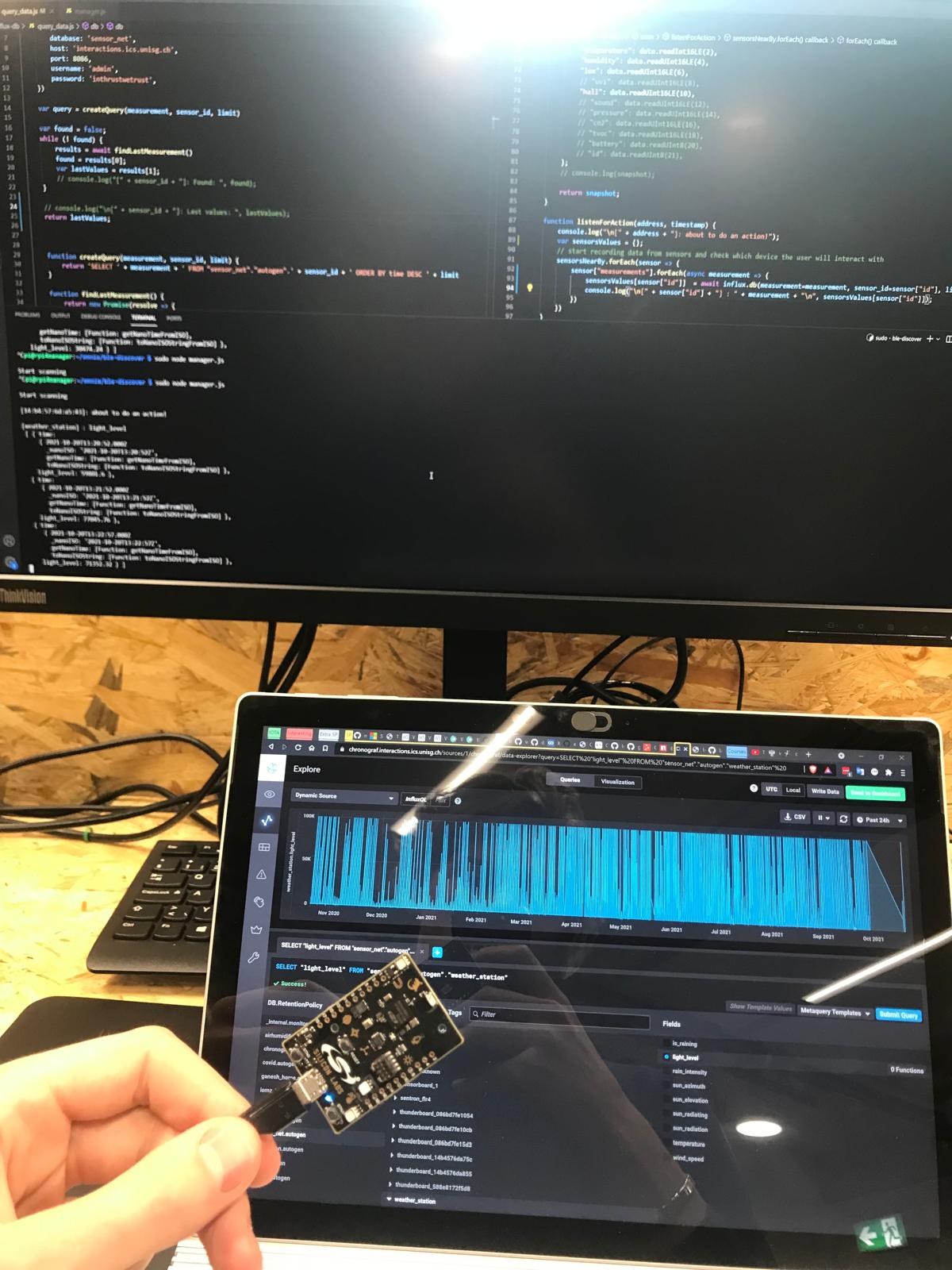 Acquiring data from a room in the lab: VS Code running the code that reads the IoT sensors and works out which device a user is near, alongside the InfluxDB / Chronograf explorer showing a year of sensor readings.