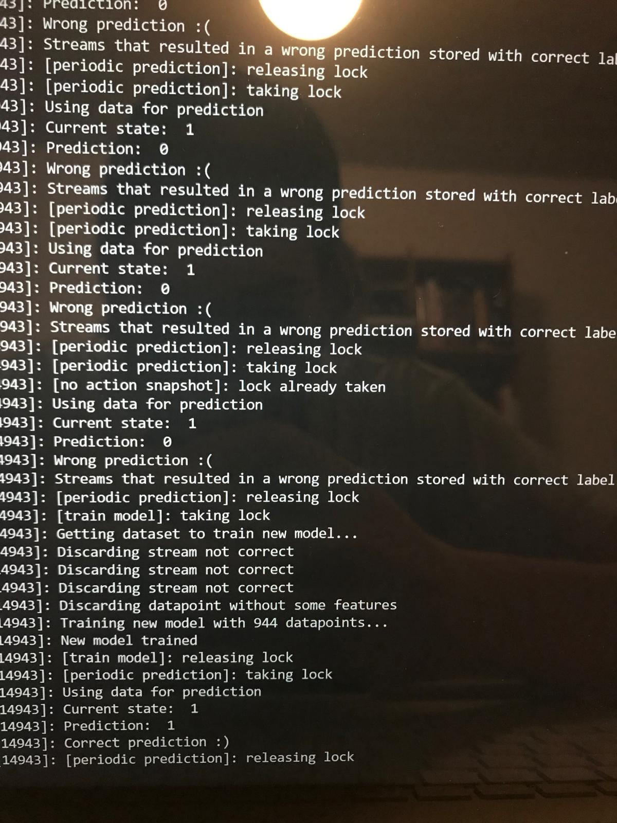 A terminal log of the system learning: repeated "Wrong prediction :(" entries, then it retrains a new model on 944 datapoints, after which the prediction turns to "Correct prediction :)".